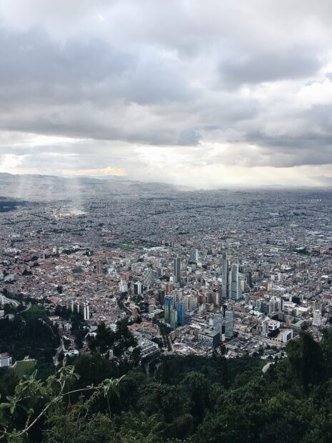 A panoramic view of Bogota city with cloudy skies and urban buildings, HD Mobile Wallpaper