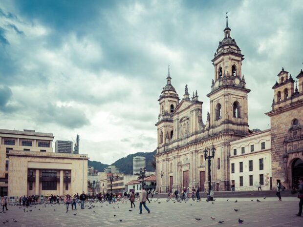 The Bogota cityscape features a large cathedral and people walking in the plaza, HD Desktop Wallpaper