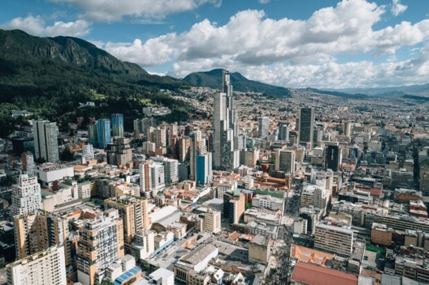 A panoramic view of Bogota city with skyscrapers and mountains in the background, 2K Desktop Wallpaper
