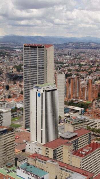 The Bogota cityscape shows tall buildings and surrounding mountains, 2K Mobile Wallpaper