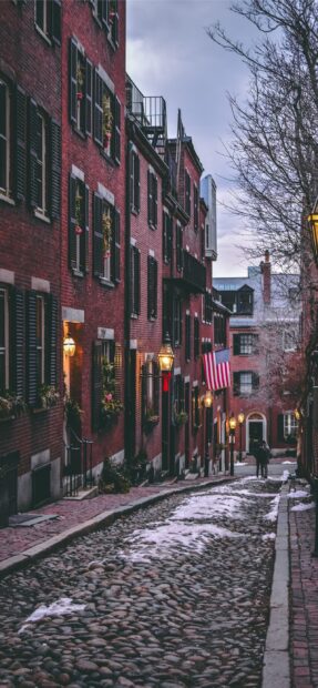 Historic Boston street with cobblestone road and brick buildings in winter twilight