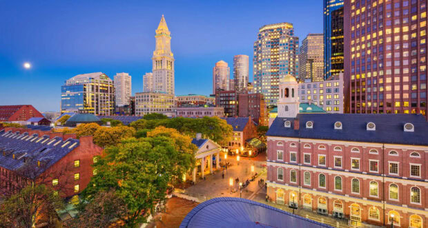 Historic Boston skyline with modern buildings and vibrant city lights at dusk