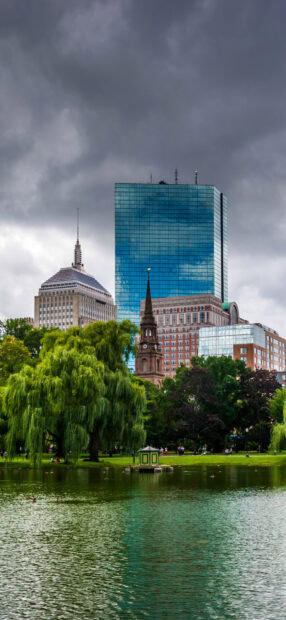 Historic Boston skyline with greenery and cloudy sky in Boston