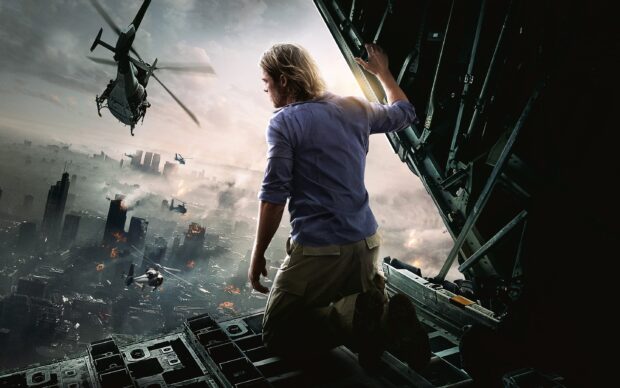 Brad Pitt kneeling at the open ramp of a military aircraft overlooking a city under attack