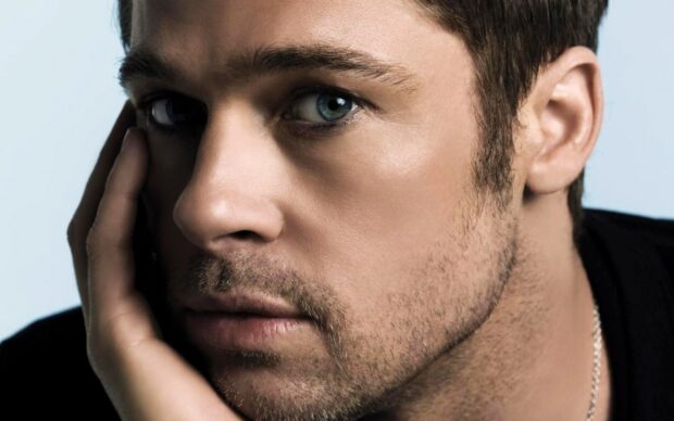 Close up of Brad Pitt with a contemplative expression on his face