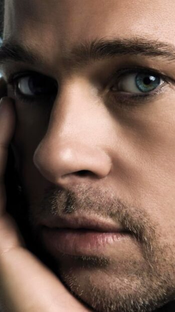 Close up of Brad Pitt with a thoughtful expression and blue eyes