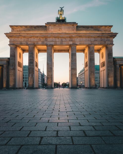 The Brandenburg Gate in Berlin stands tall against the evening sky, showcasing its historic architecture, 2K Mobile Wallpaper