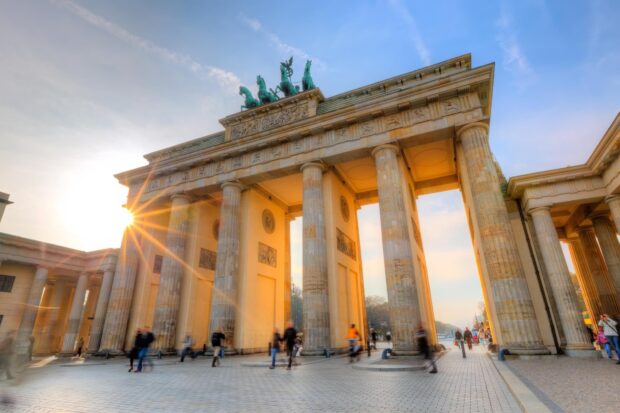 The Brandenburg Gate in Berlin is captured with sunlight and people walking nearby, HD Desktop Wallpaper