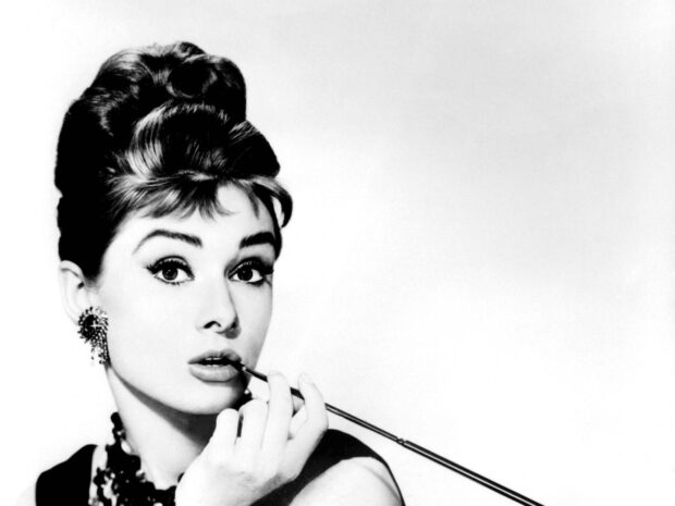 Classic Breakfast At Tiffanys portrait of a woman holding a cigarette holder near her lips