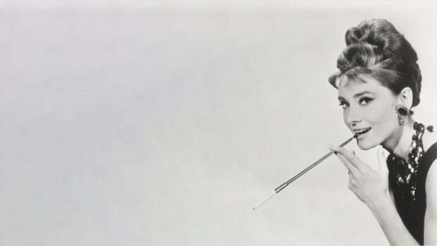 Classic Breakfast At Tiffanys scene with elegant woman holding cigarette holder