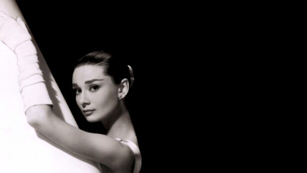 Audrey Hepburn from Breakfast At Tiffanys posing elegantly with white gloves