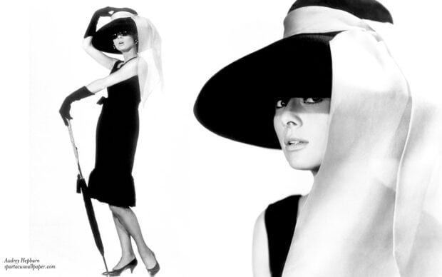 Audrey Hepburn wearing a black dress and large hat in Breakfast At Tiffanys