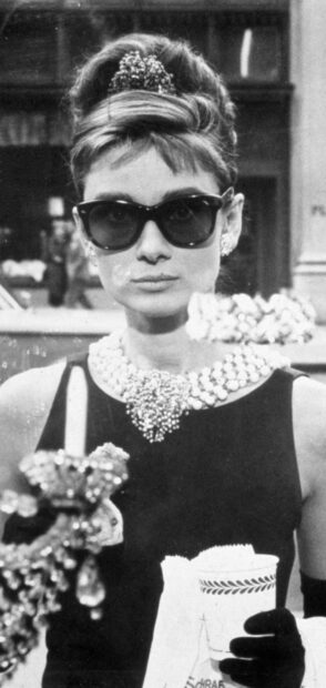 Audrey Hepburn wearing sunglasses and elegant jewelry in Breakfast At Tiffanys scene