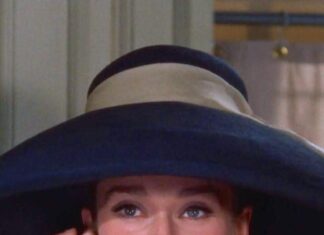 Woman wearing a large hat and elegant earrings in Breakfast At Tiffanys scene