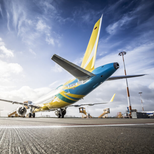 A Cebu Pacific Air airplane is parked on the airport runway under a cloudy sky, HD Desktop Wallpaper
