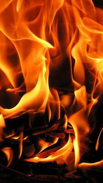 Bright flames burning intensely in the fireplace with glowing embers visible inside, HD Mobile Wallpaper