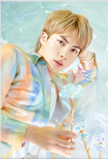 Jin BTS looks serene holding a decorative object, HD Mobile Wallpaper