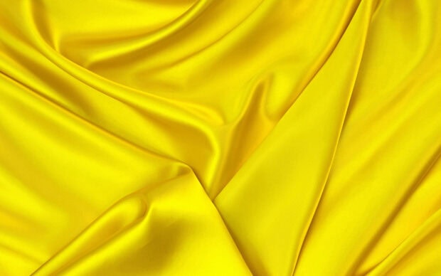 Smooth yellow silk fabric showcases rich texture and folds, 2K Desktop Wallpaper