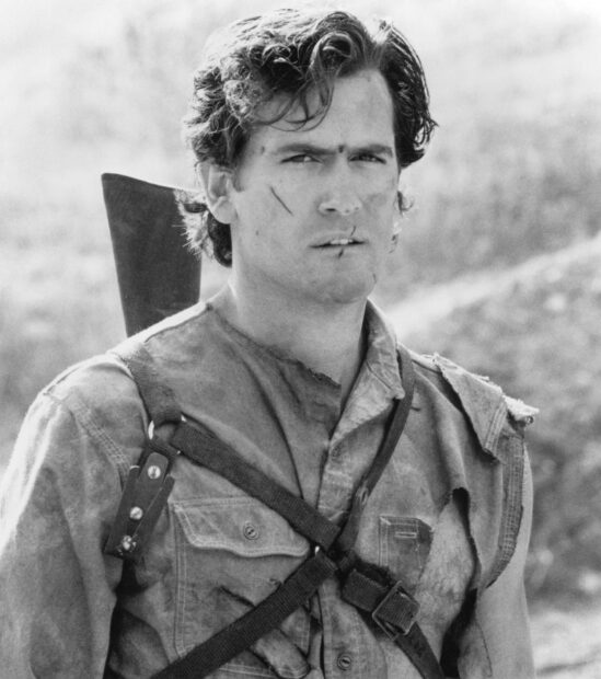 Bruce Campbell stands with scars and rugged attire in a dramatic scene, HD Desktop Wallpaper