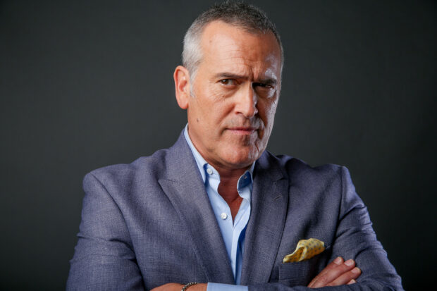 A confident middle aged man in a blue suit posing with folded arms, 2K Desktop Wallpaper