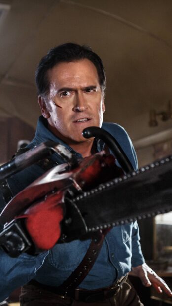 Bruce Campbell holding a chainsaw with a focused expression in a tense scene, 4K Phone Wallpaper