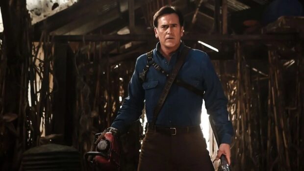 Bruce Campbell wallpapers shows him holding a chainsaw and shotgun in a barn, HD Desktop Wallpaper