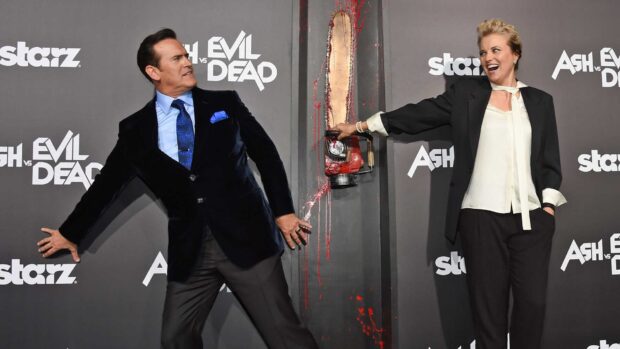 Bruce Campbell wallpapers showing him posing with a woman and a chainsaw prop, HD Desktop Wallpaper
