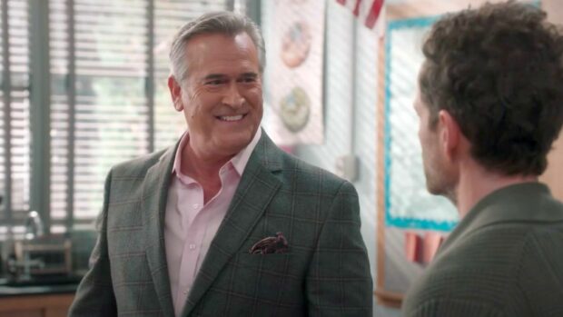 Bruce Campbell smiles while talking in a room with windows, HD Desktop Wallpaper