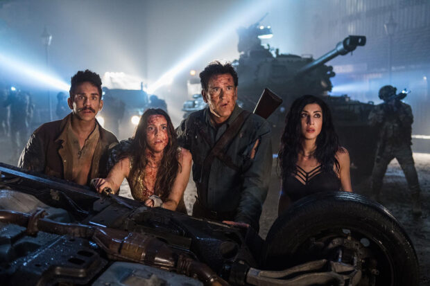 Bruce Campbell and co stars face danger behind wrecked car in tense scene, HD Desktop Wallpaper