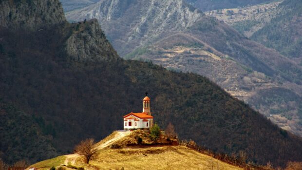 A small church on a hill surrounded by mountains in Bulgaria wallpapers, 4K Desktop Wallpaper