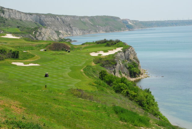 A beautiful view of Bulgaria with a golf course along the coastline and calm sea, 2K Desktop Wallpaper