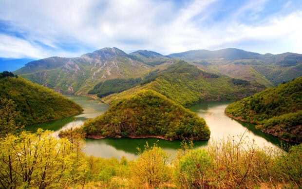 The Bulgaria wallpapers capture a scenic river winding through lush green mountains, HD Desktop Wallpaper
