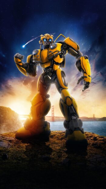 Bumblebee robot standing on a cliff with the Golden Gate Bridge in the background at sunset