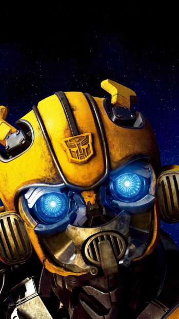 Close up of Bumblebee Transformers with glowing blue eyes under starry night sky