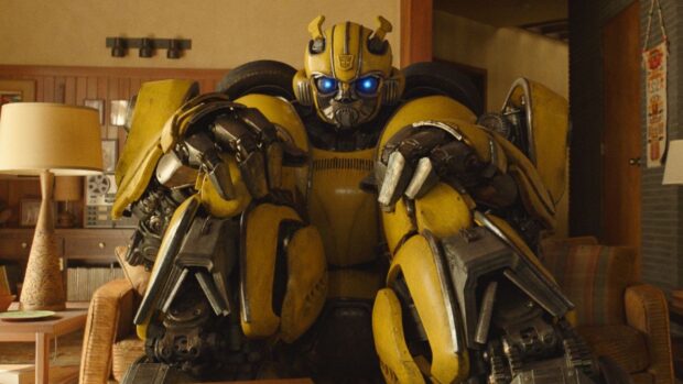 Bumblebee Autobot robot sitting inside a living room with glowing blue eyes