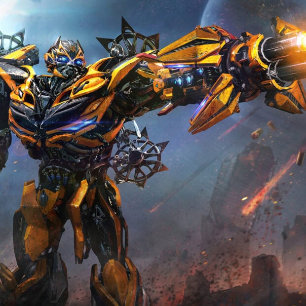 Bumblebee robot from Transformers is aiming a large futuristic gun in a battle scene