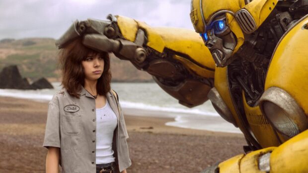 Woman standing on the beach with Bumblebee Transformers touching her head