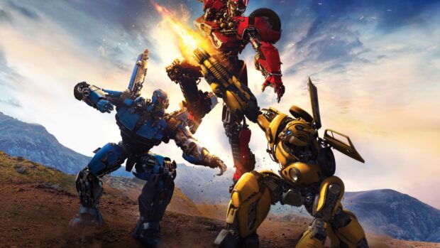 Bumblebee and two other robots are engaged in a dynamic battle scene on a rocky landscape at sunset
