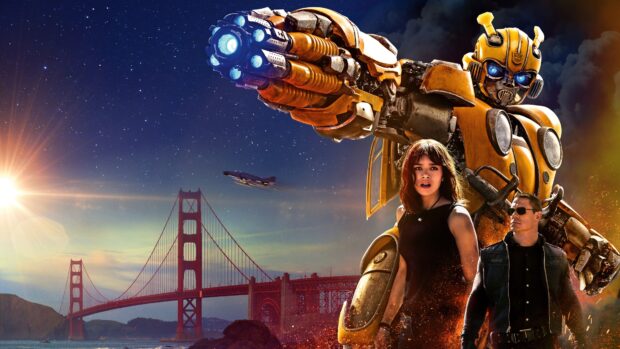 Bumblebee stands with two humans near the Golden Gate Bridge under a starry sky
