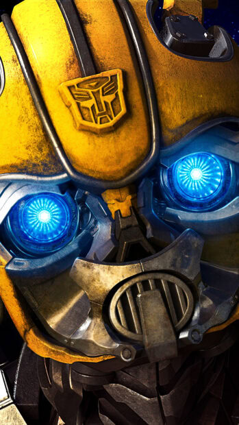 A close up of Bumblebee's face with glowing blue eyes and detailed mechanical features