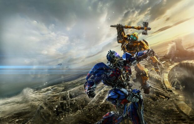 Bumblebee robot is raising a hammer to strike another blue and red robot in a dramatic battle scene