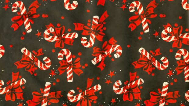 Red festive candy cane pattern with bows and stars on a dark background