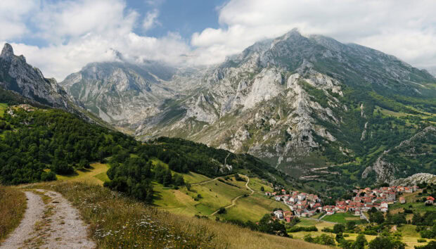 Scenic view of Cantabrian Mountains with green hills and a village nestled at the base