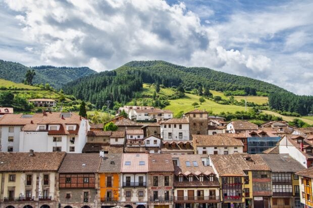 Traditional houses with green hills in the Cantabrian Mountains landscape