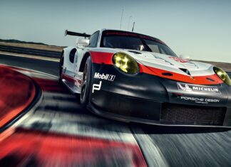 A high performance car race speeding on a curvy track at a professional racing circuit