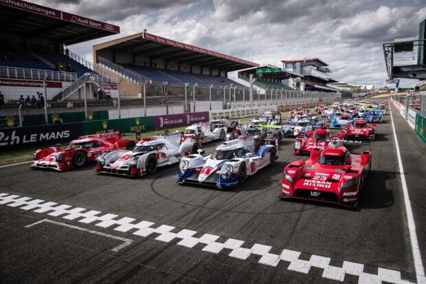 Racing cars lined up at the starting grid in a car race event at the Le Mans track