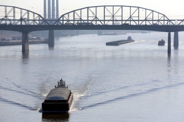 A cargo barge is traveling under a steel bridge on the Mississippi River, HD Desktop Wallpaper