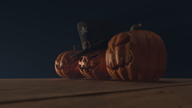 Three carved Halloween pumpkins with one wearing a pirate hat on a dark background, HD Desktop Wallpaper