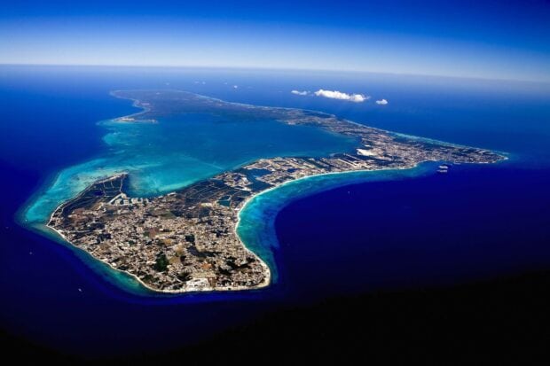 Aerial view of Cayman Islands with turquoise waters and coastal landscape in clear weather