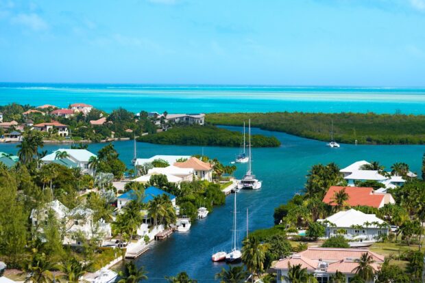Aerial view of Cayman Islands with turquoise water and lush greenery along the coastline